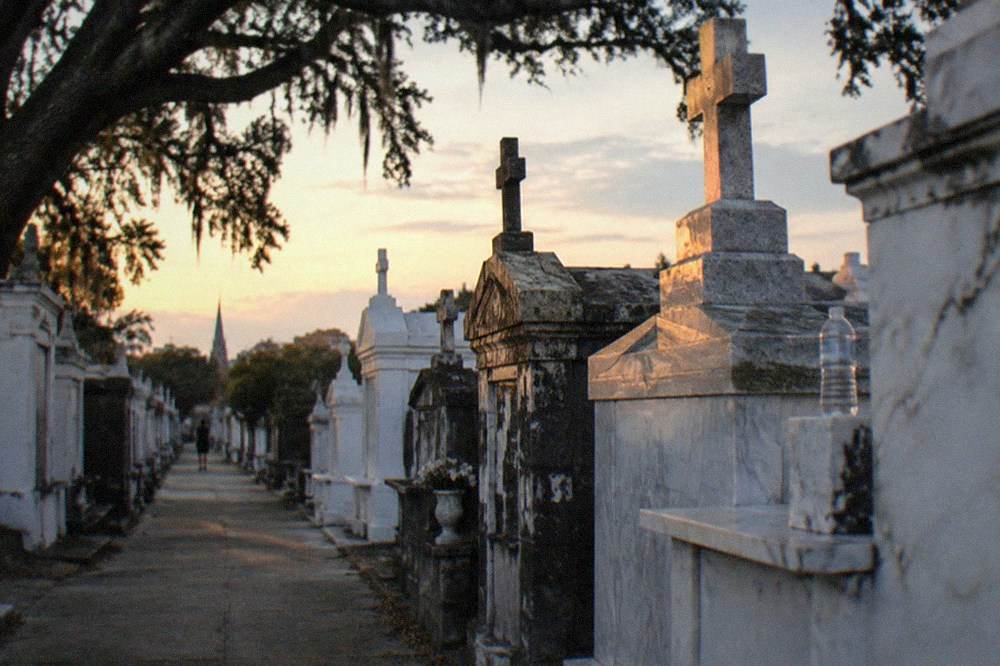 Above-ground stone tombs in a New Orleans cemetery at dusk