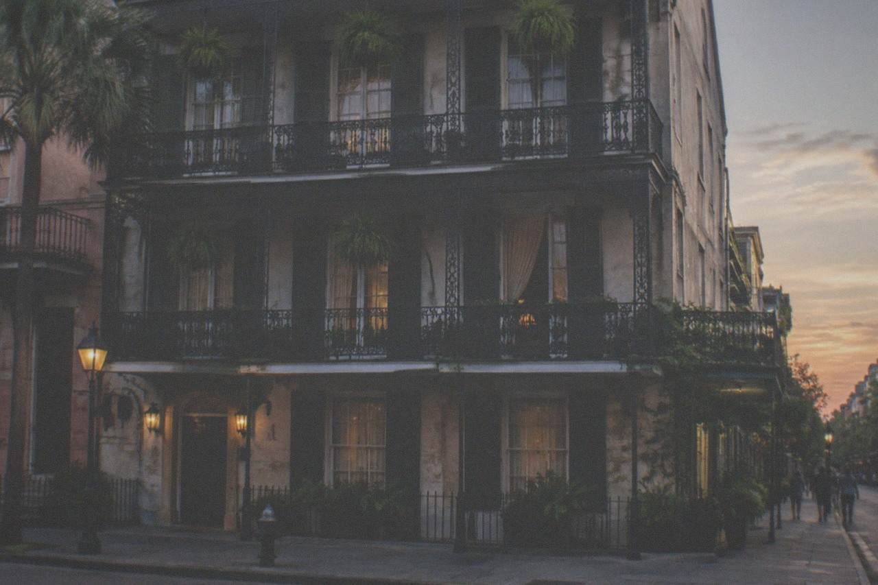 The three-story French Quarter facade of the LaLaurie Mansion on Royal Street at dusk