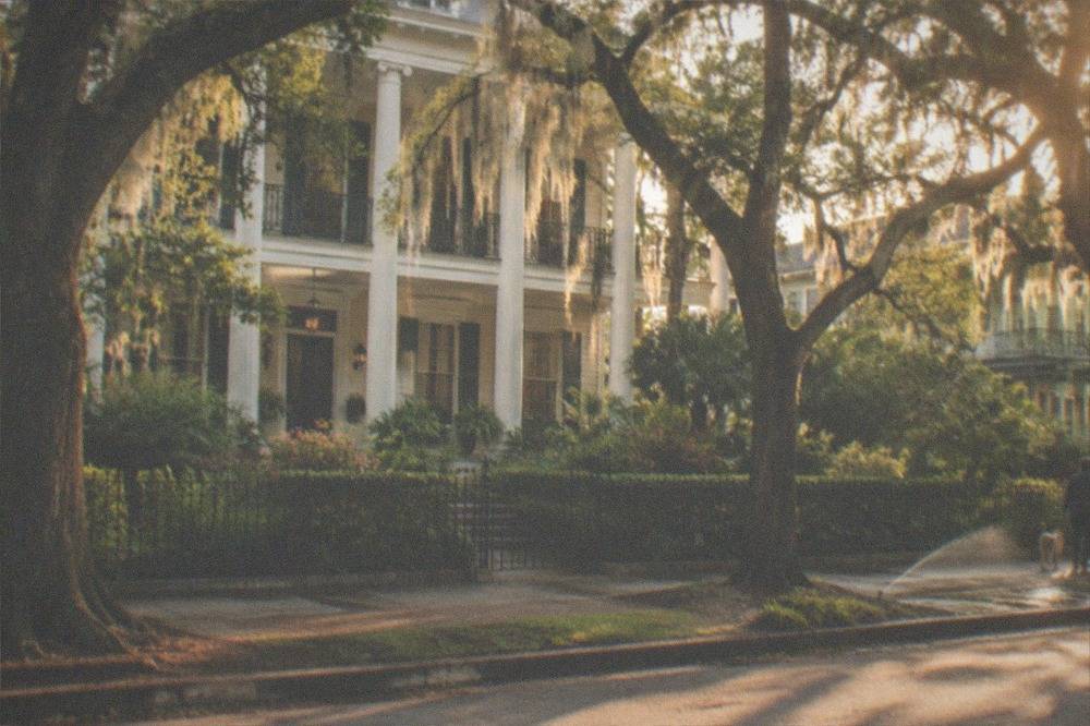 Garden District mansion and live oaks on a quiet street near the closed cemetery
