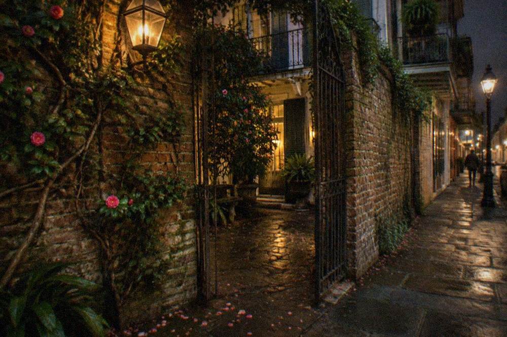 Lantern light on a French Quarter courtyard wall at night