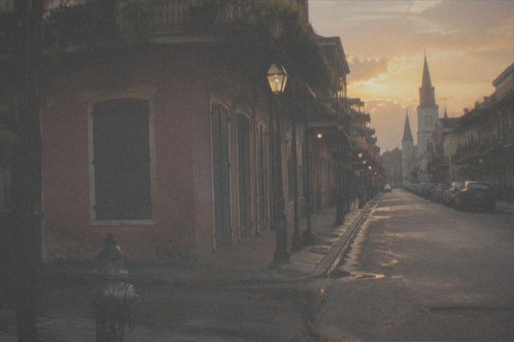 Empty French Quarter street corner under a warm evening sky