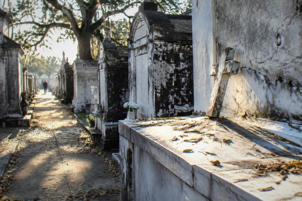Rows of weathered above-ground tombs along a walkway in St. Louis Cemetery No. 3