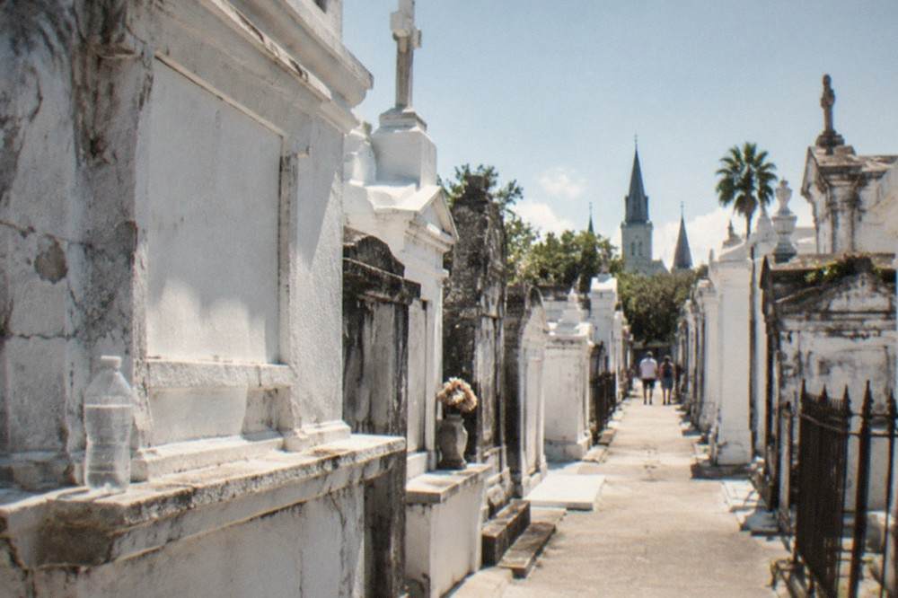 Rows of above-ground tombs along a narrow walkway in St. Louis Cemetery