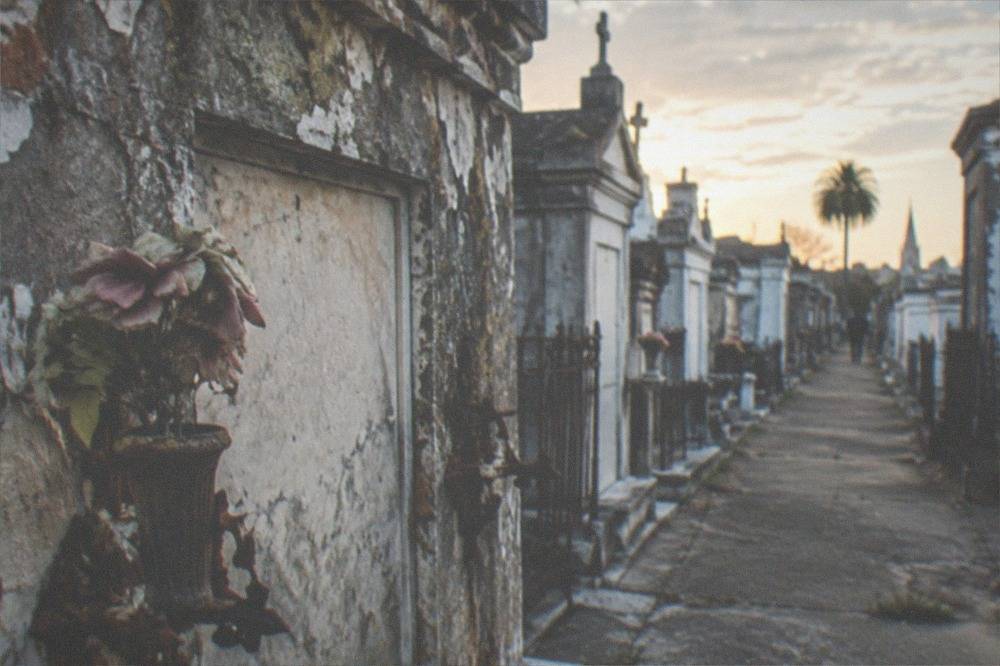 Close view of aged plaster tombs with iron decorations in an old New Orleans cemetery