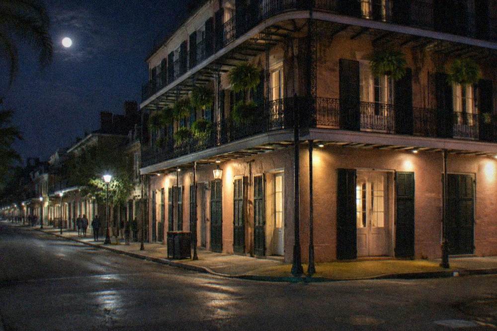 Illuminated corner building on North Rampart Street at night
