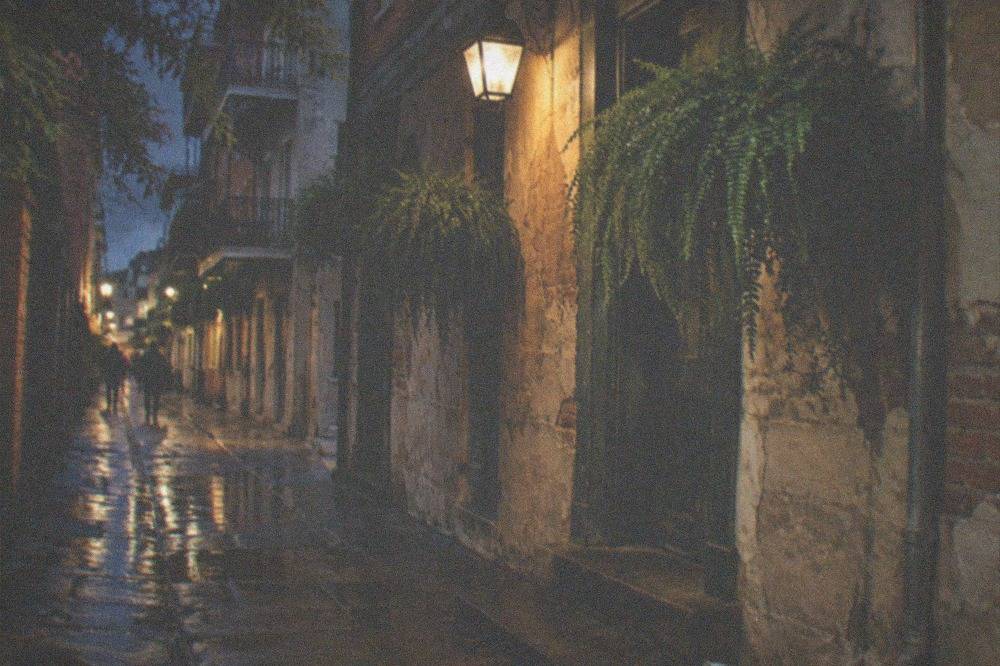Narrow Exchange Place alley lit by a single hanging lamp