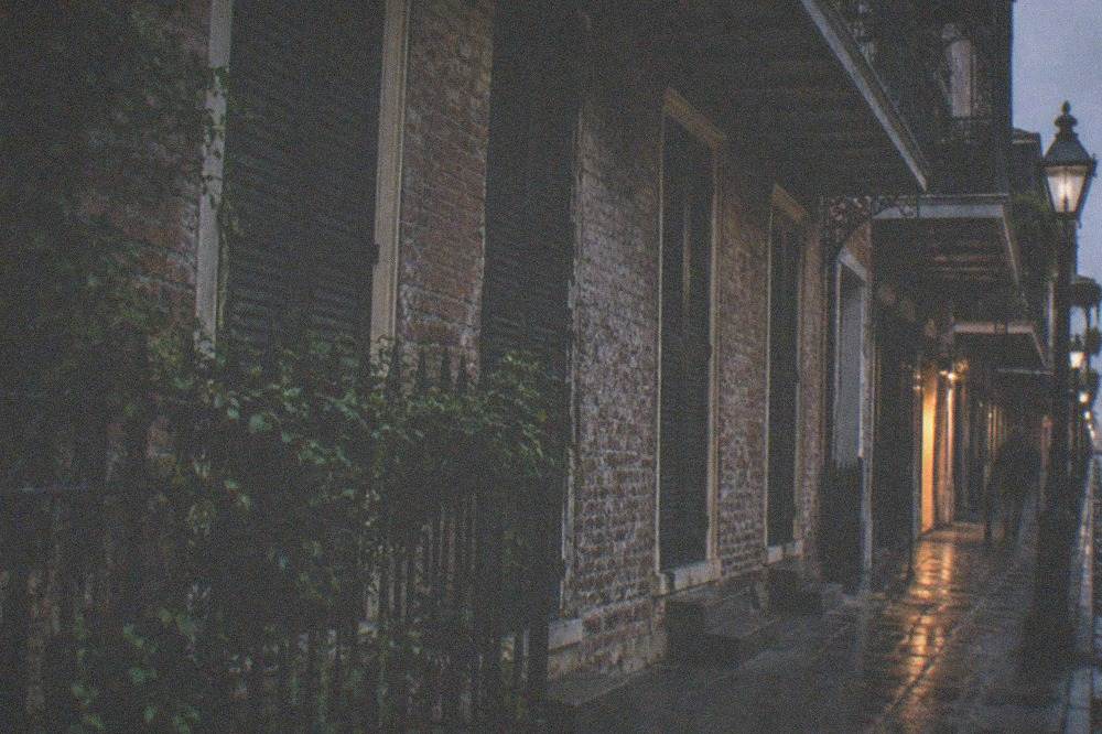 Historic French Quarter building facade with dark windows at night